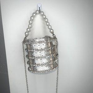 This is a vintage women’s crossbody bag with gold,silver and pearls .